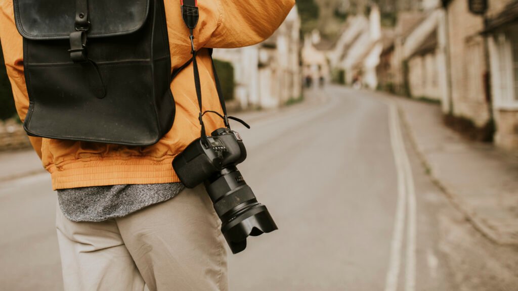 dslr-camera-with-strap-hanging-photographer-rsquo-s-shoulder-scaled
